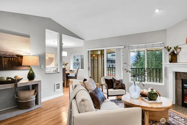 a living room with furniture and floor to ceiling windows