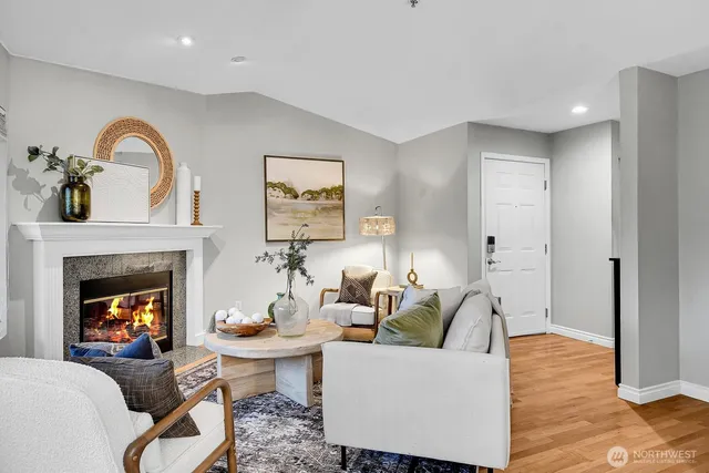 a living room with furniture a fireplace and a table