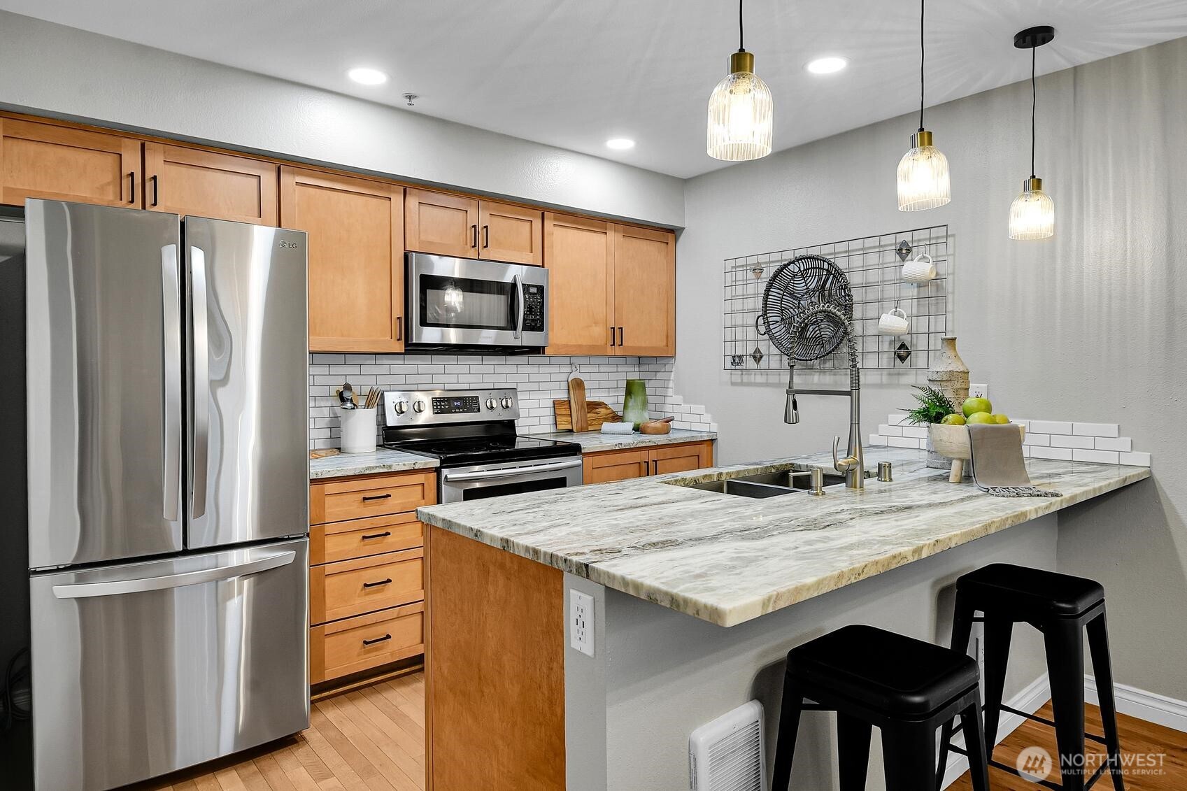 18930 Bothell Everett Highway, Unit F305 Bothell, WA 98012 - Photo 6 of 20 a kitchen with granite countertop stainless steel appliances a refrigerator a stove a sink cabinets and a dining table