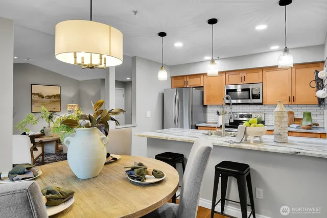 a kitchen with a dining table cabinets and appliances