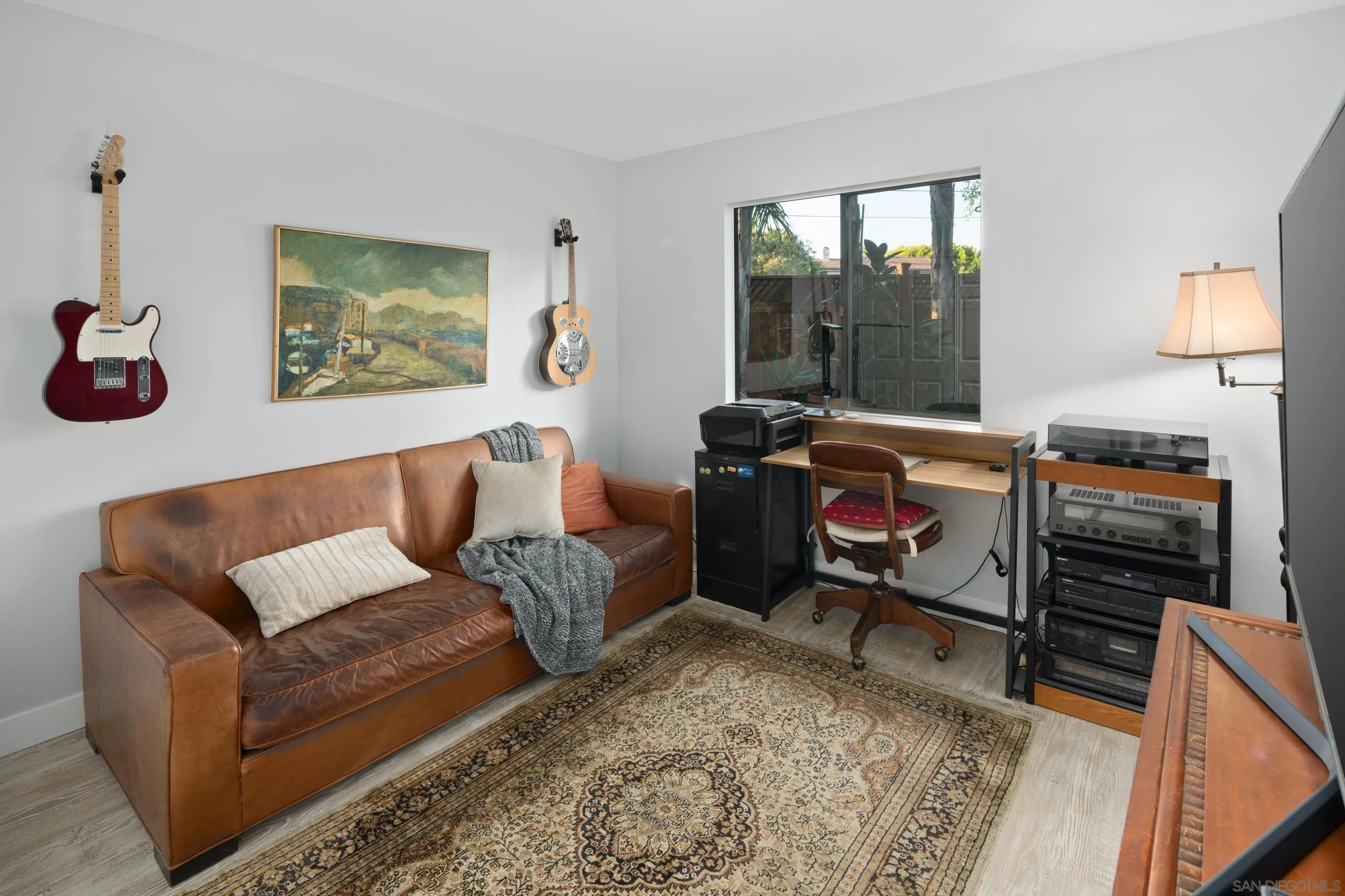 1557 Summit Avenue Cardiff, CA 92007 - Photo 13 of 28 a living room with furniture a flat screen tv and a window