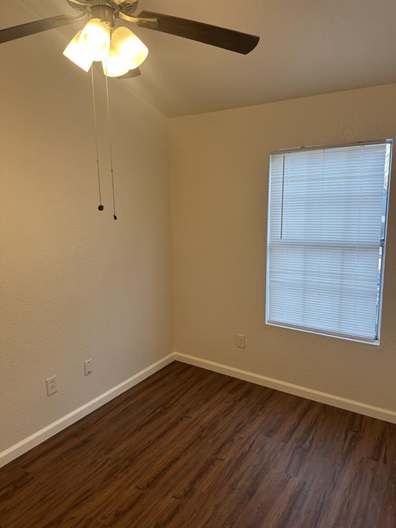 2400 Jupiter Road, Unit D2 Plano, TX 75074 - Photo 12 of 17 Unfurnished room with dark wood-style flooring and a ceiling fan