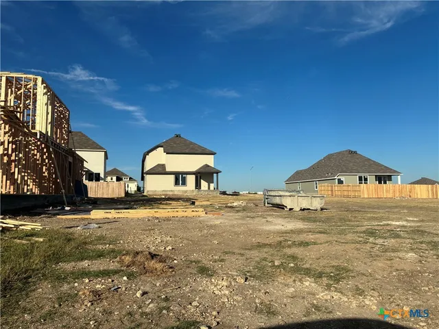 a large house with a big yard and large trees
