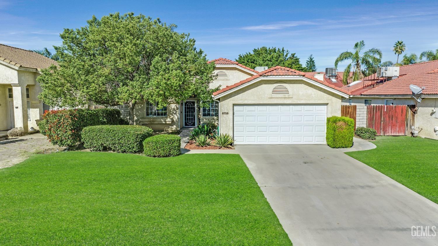 Undisclosed Address Bakersfield, CA 93312 - Photo 1 of 43 a front view of a house with a garden and plants