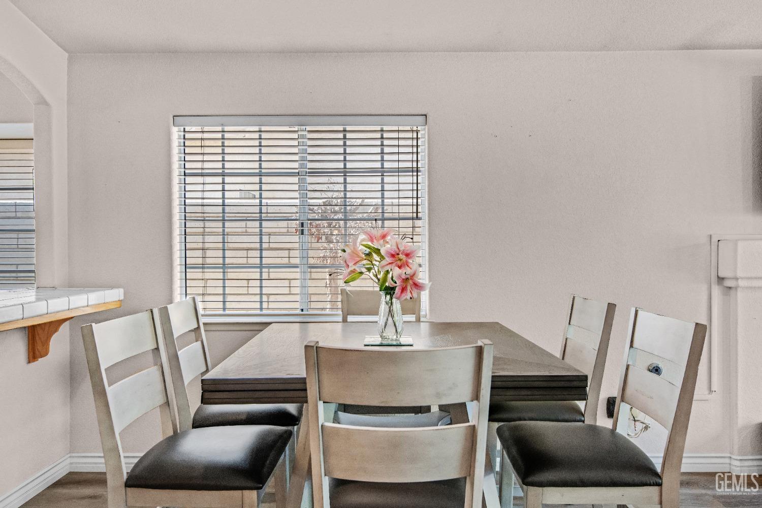 Undisclosed Address Bakersfield, CA 93312 - Photo 12 of 43 a dining room with furniture and wooden floor