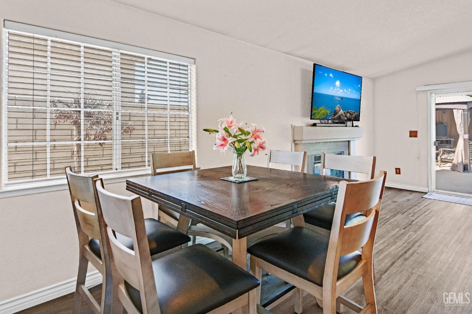 Undisclosed Address Bakersfield, CA 93312 - Photo 13 of 43 a view of a dining room with furniture and wooden floor