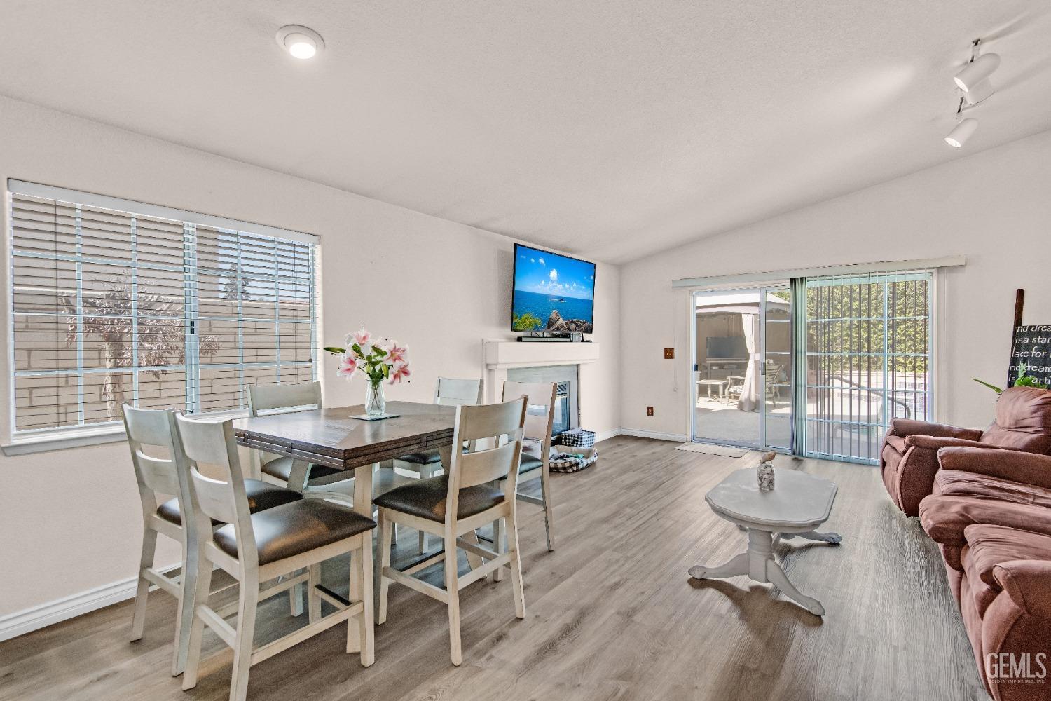 Undisclosed Address Bakersfield, CA 93312 - Photo 14 of 43 a view of a dining room with furniture large windows and wooden floor