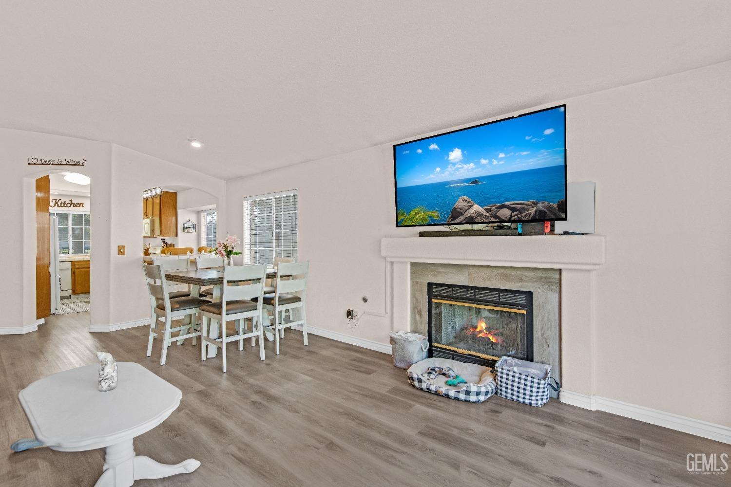 Undisclosed Address Bakersfield, CA 93312 - Photo 16 of 43 a living room with furniture a fireplace and a table