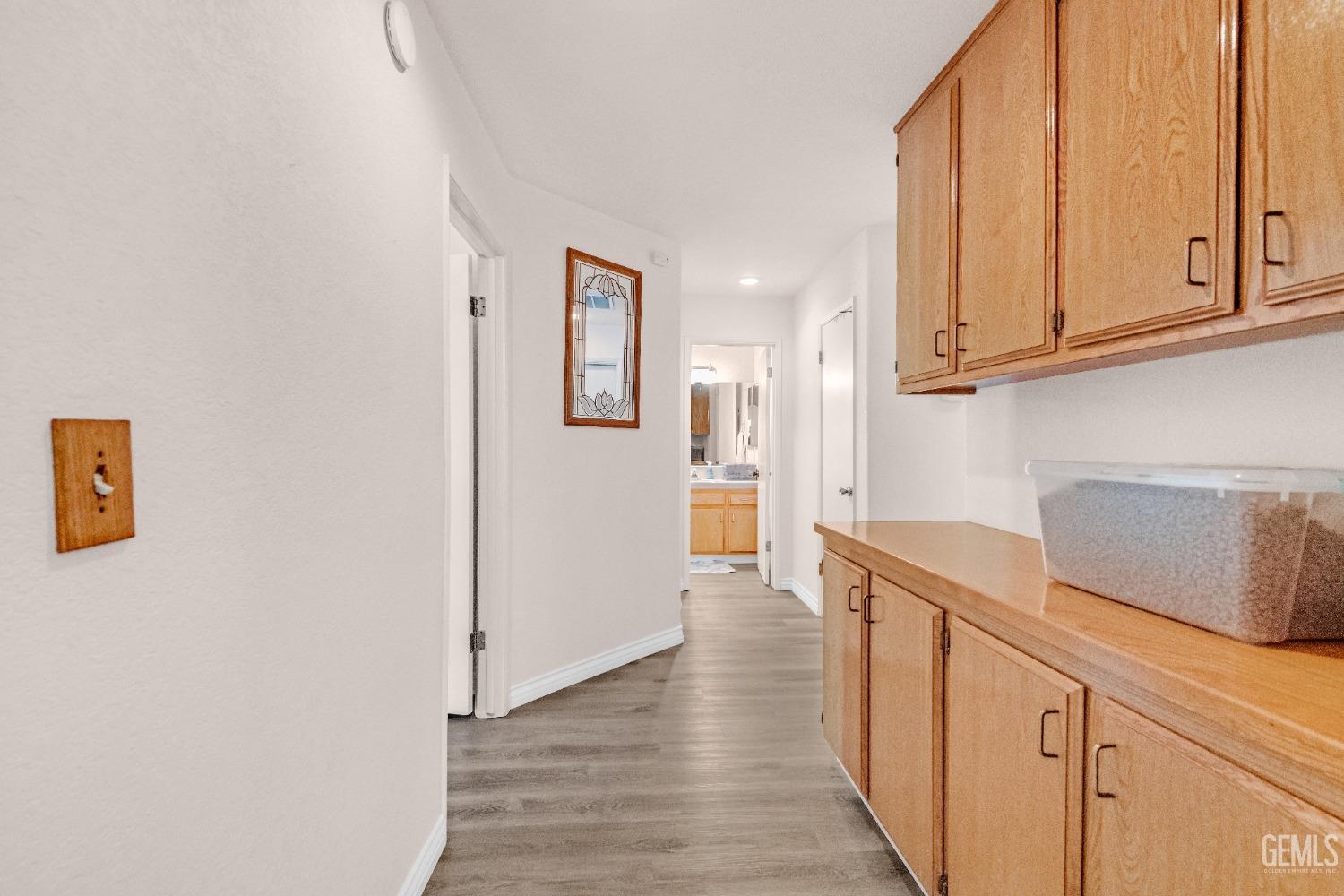 Undisclosed Address Bakersfield, CA 93312 - Photo 19 of 43 a view of a kitchen with wooden floor and cabinets