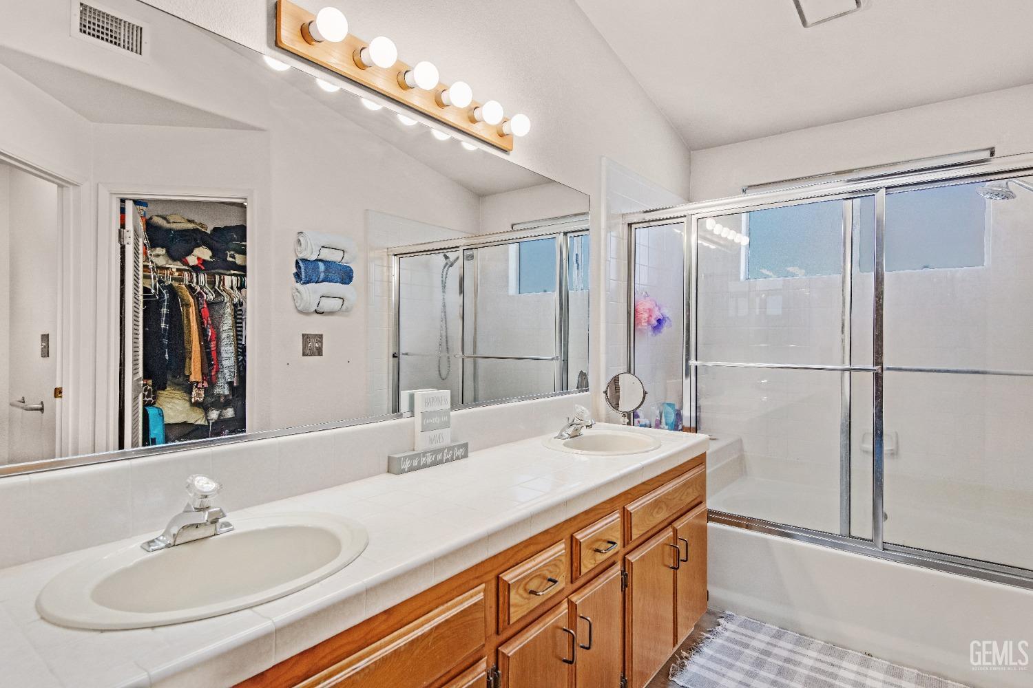 Undisclosed Address Bakersfield, CA 93312 - Photo 23 of 43 a bathroom with a sink double vanity and a mirror