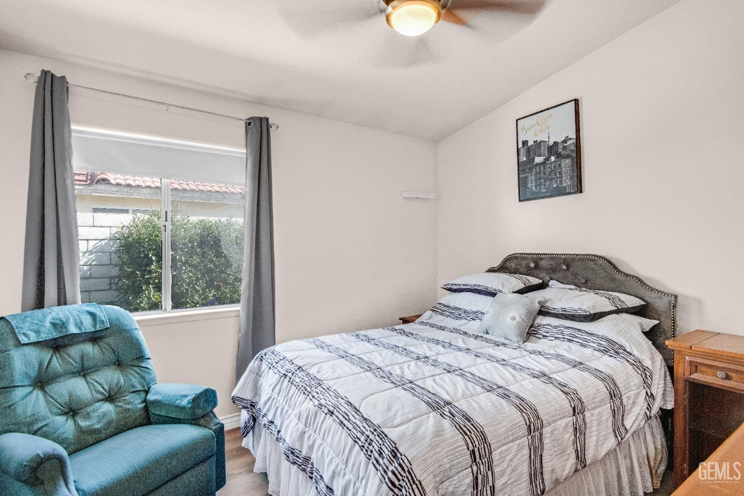 Undisclosed Address Bakersfield, CA 93312 - Photo 25 of 43 a bedroom with bed couch and window