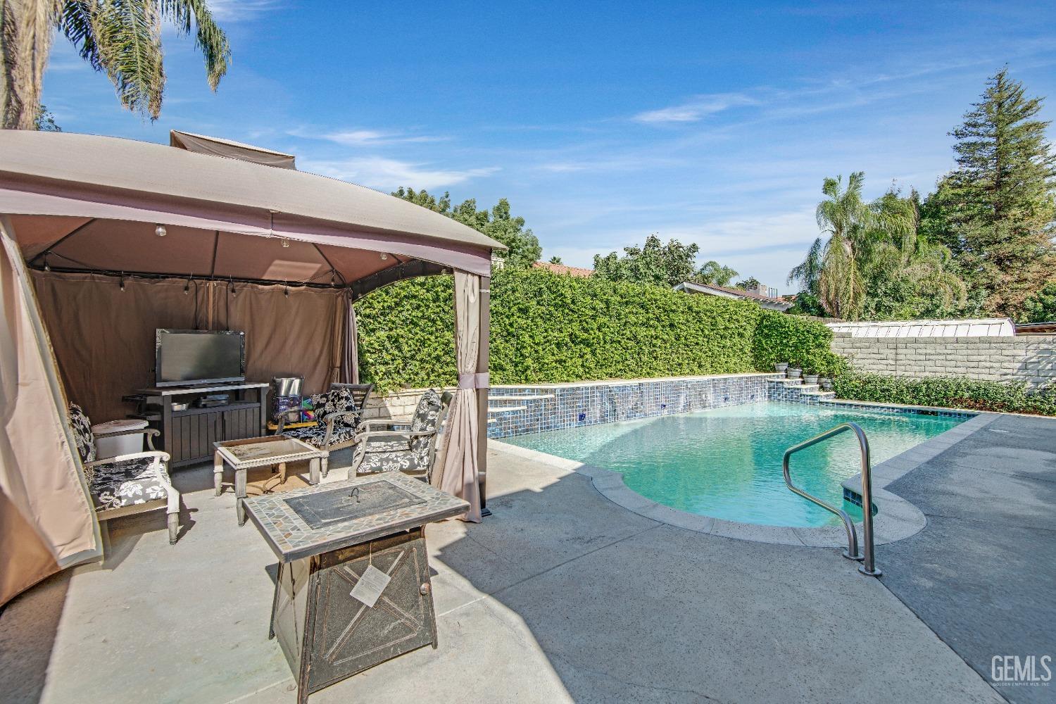 Undisclosed Address Bakersfield, CA 93312 - Photo 29 of 43 a view of backyard with swimming pool and outdoor seating