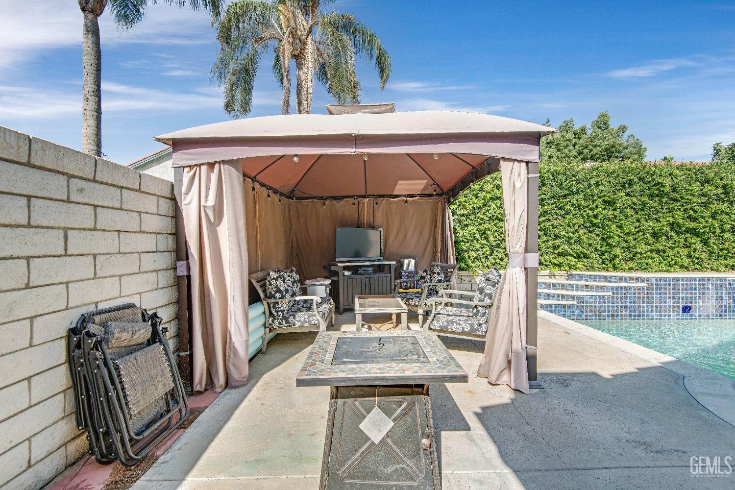 Undisclosed Address Bakersfield, CA 93312 - Photo 30 of 43 a view of a patio with table and chairs potted plants with wooden floor