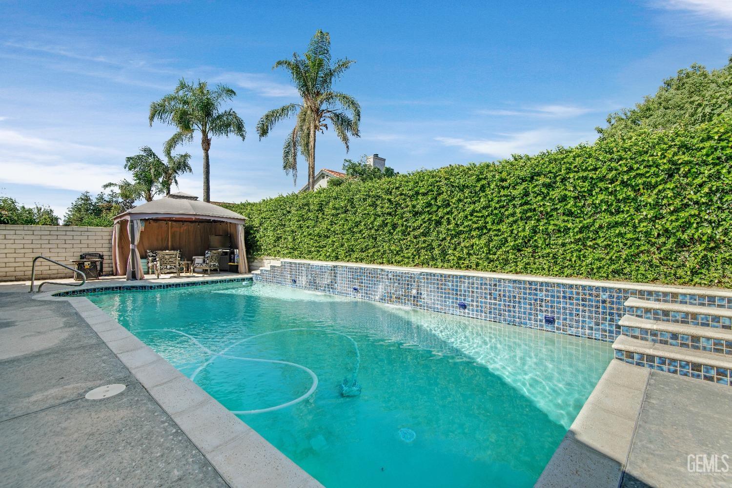 Undisclosed Address Bakersfield, CA 93312 - Photo 34 of 43 a view of a garden with a bench