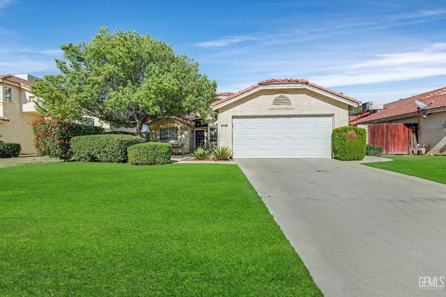 Undisclosed Address Bakersfield, CA 93312 - Photo 41 of 43 a view of a house with a small yard and a large tree