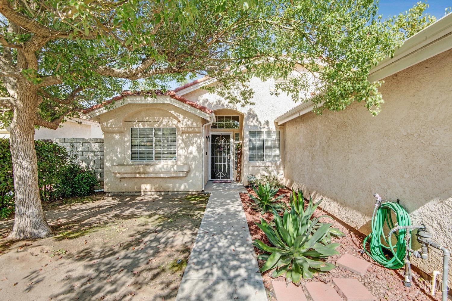 Undisclosed Address Bakersfield, CA 93312 - Photo 6 of 43 a front view of a house with a yard