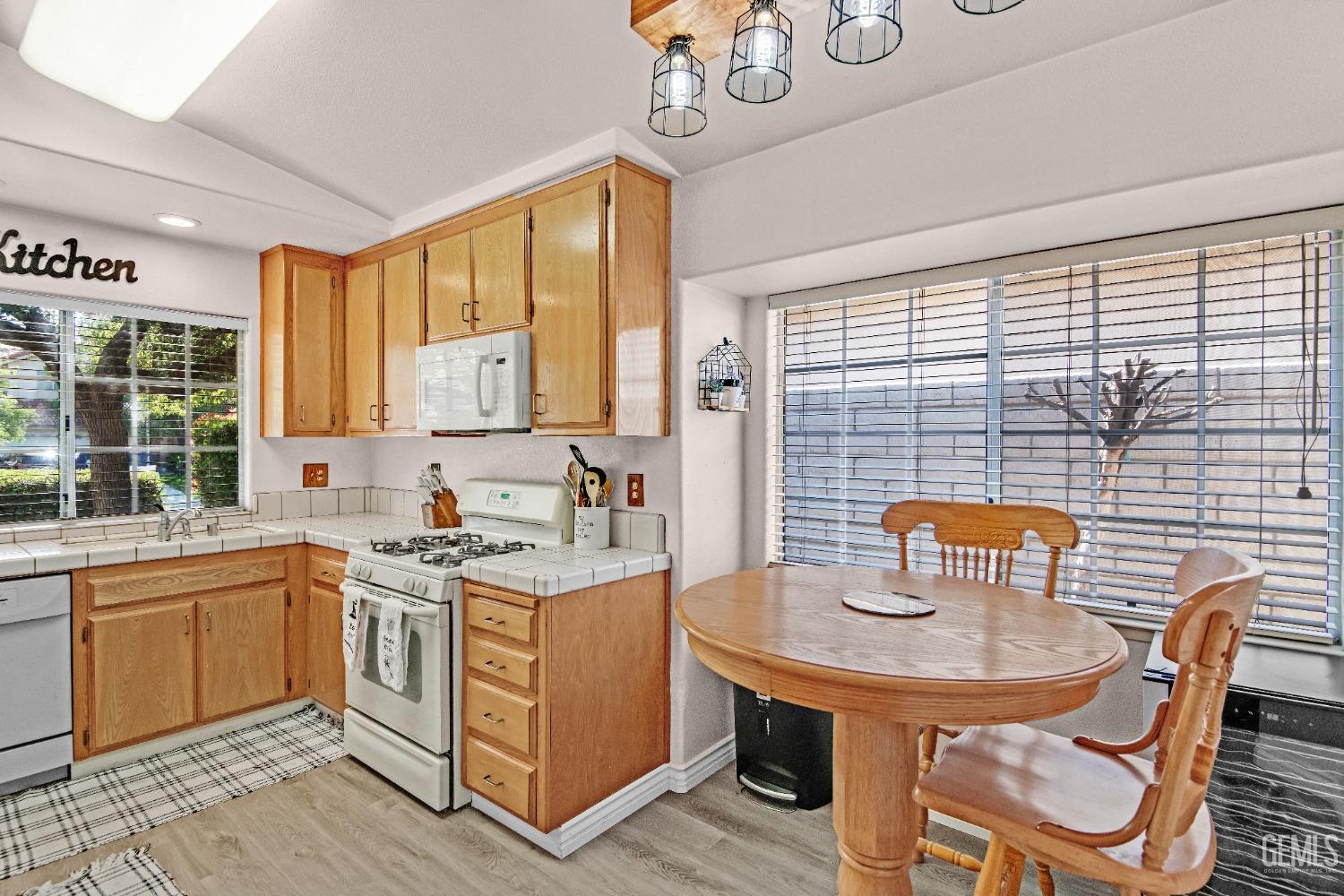 Undisclosed Address Bakersfield, CA 93312 - Photo 8 of 43 a kitchen with a sink a table and chairs in it