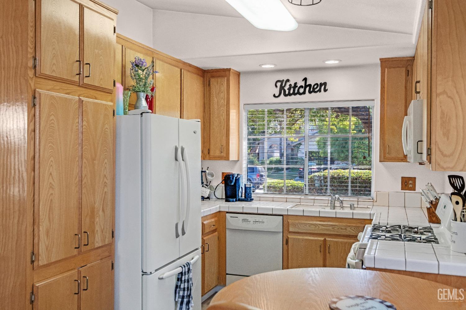 Undisclosed Address Bakersfield, CA 93312 - Photo 9 of 43 a kitchen with stainless steel appliances a refrigerator sink and cabinets