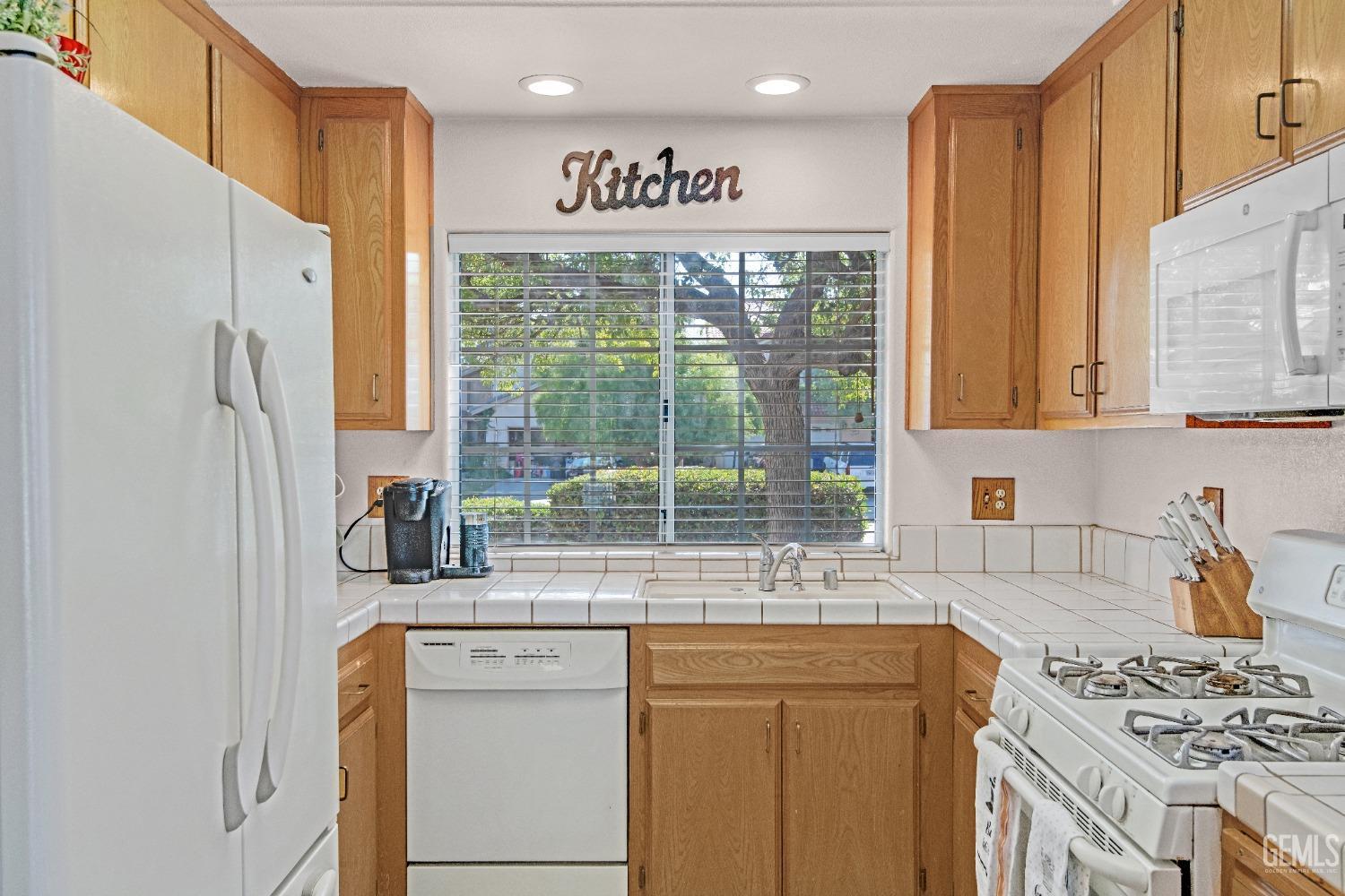 Undisclosed Address Bakersfield, CA 93312 - Photo 10 of 43 a kitchen with stainless steel appliances granite countertop a refrigerator a sink a stove and white cabinets