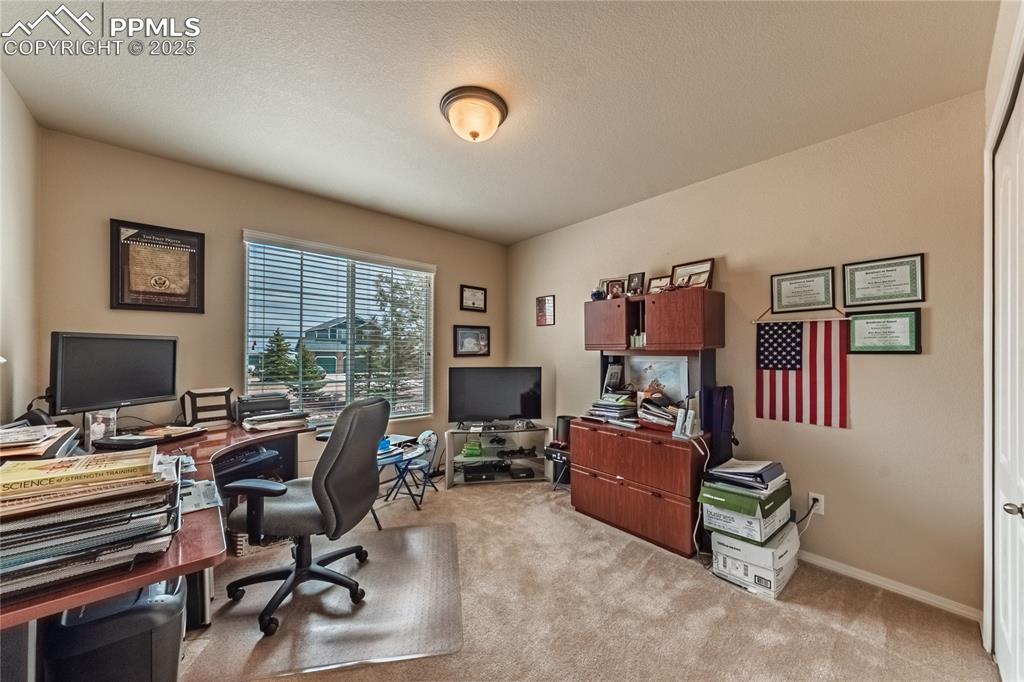 11171 Allendale Drive Peyton, CO 80831 - Photo 11 of 50 a work room with furniture and a bookshelf
