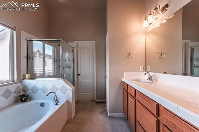a bathroom with a tub sink and mirror