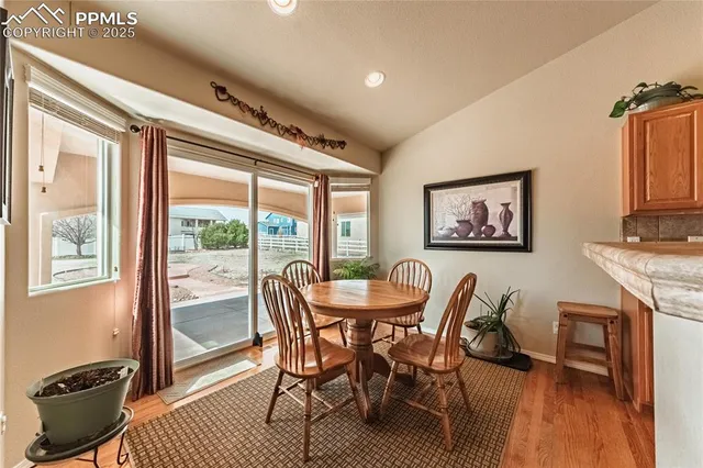 a view of a dining room with furniture window and wooden floor