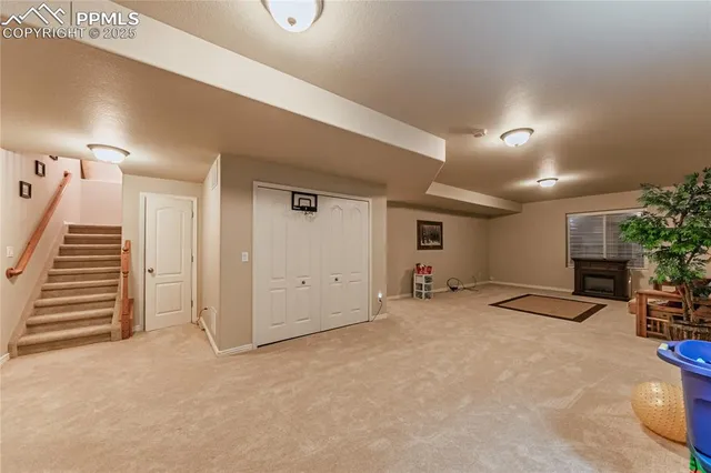 a view of a livingroom with furniture and staircase