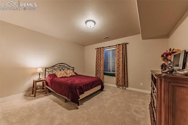 a spacious bedroom with a bed and a dresser