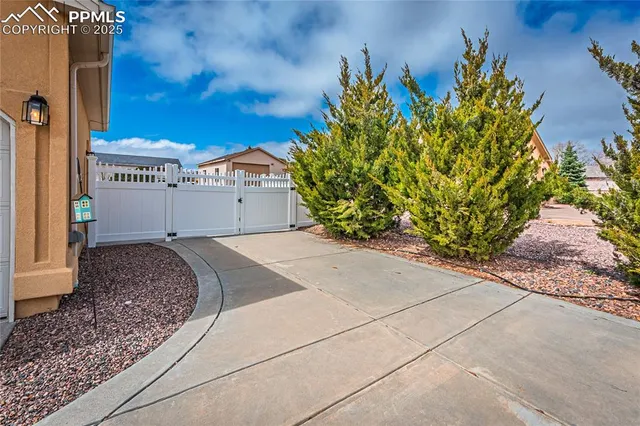 a view of a house with a yard and potted plants