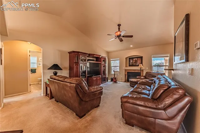 a living room with furniture a couch and a flat screen tv