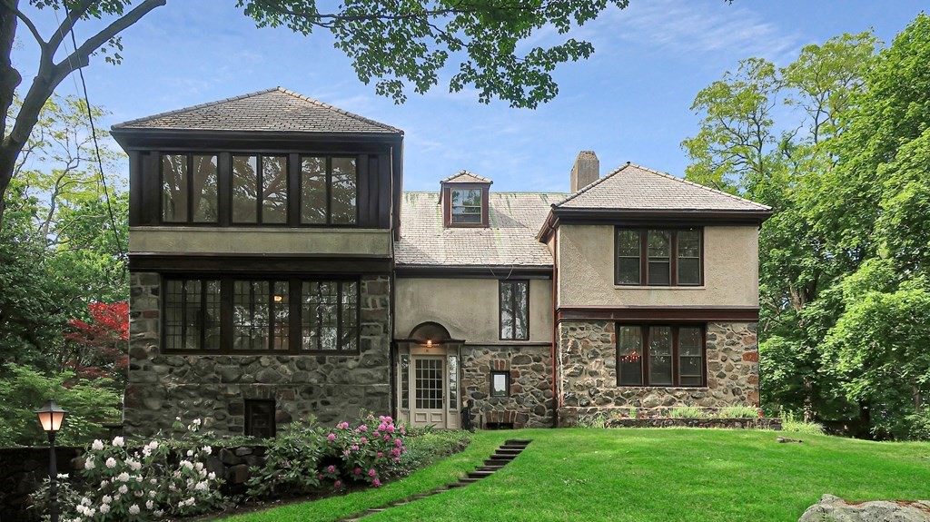 a front view of a house with garden