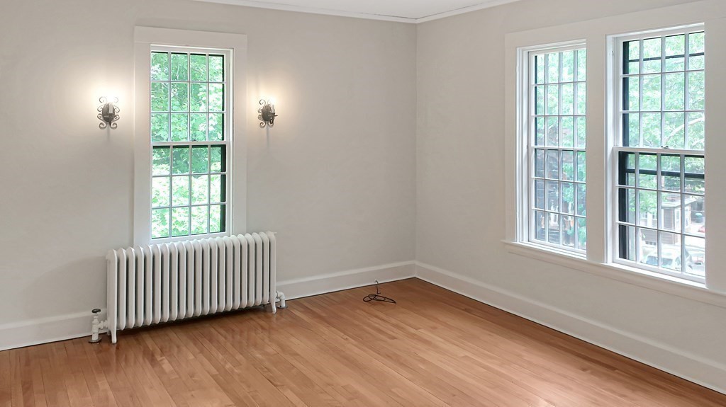 39 Locust Avenue Lexington, MA 02421 - Photo 13 of 32 an empty room with wooden floor and windows
