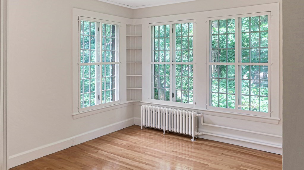 39 Locust Avenue Lexington, MA 02421 - Photo 14 of 32 a view of an empty room with wooden floor and a window