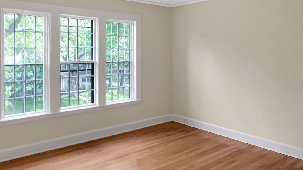 39 Locust Avenue Lexington, MA 02421 - Photo 18 of 32 a view of an empty room with wooden floor and a window