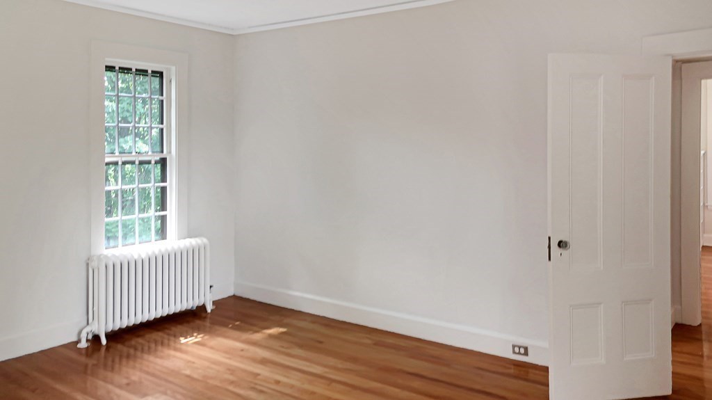 39 Locust Avenue Lexington, MA 02421 - Photo 19 of 32 an empty room with wooden floor and windows