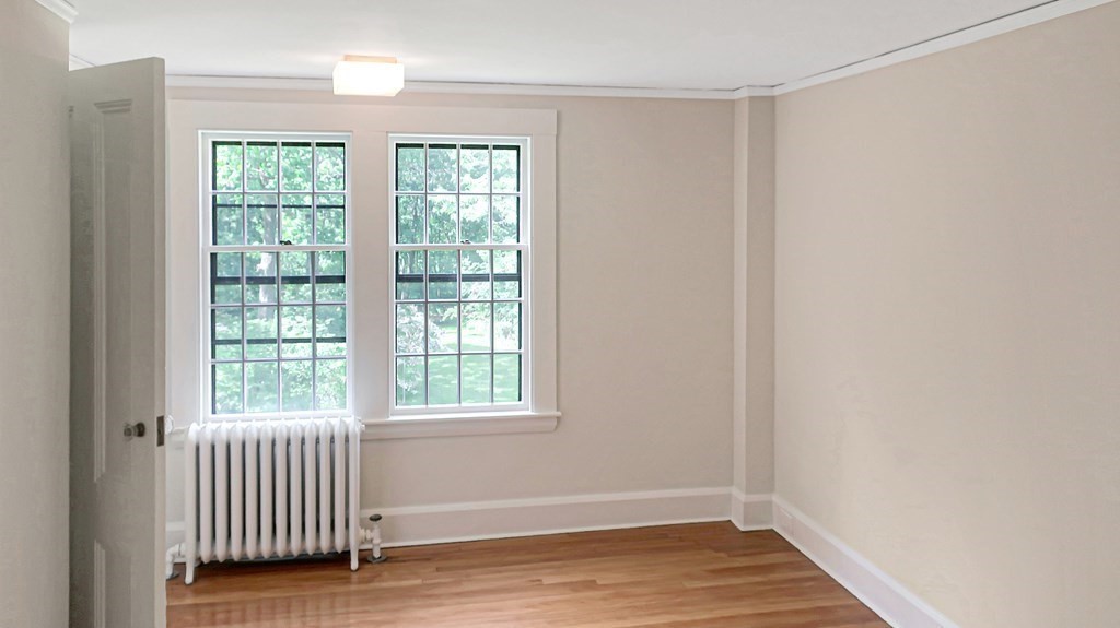 39 Locust Avenue Lexington, MA 02421 - Photo 20 of 32 a view of an empty room with wooden floor and a window