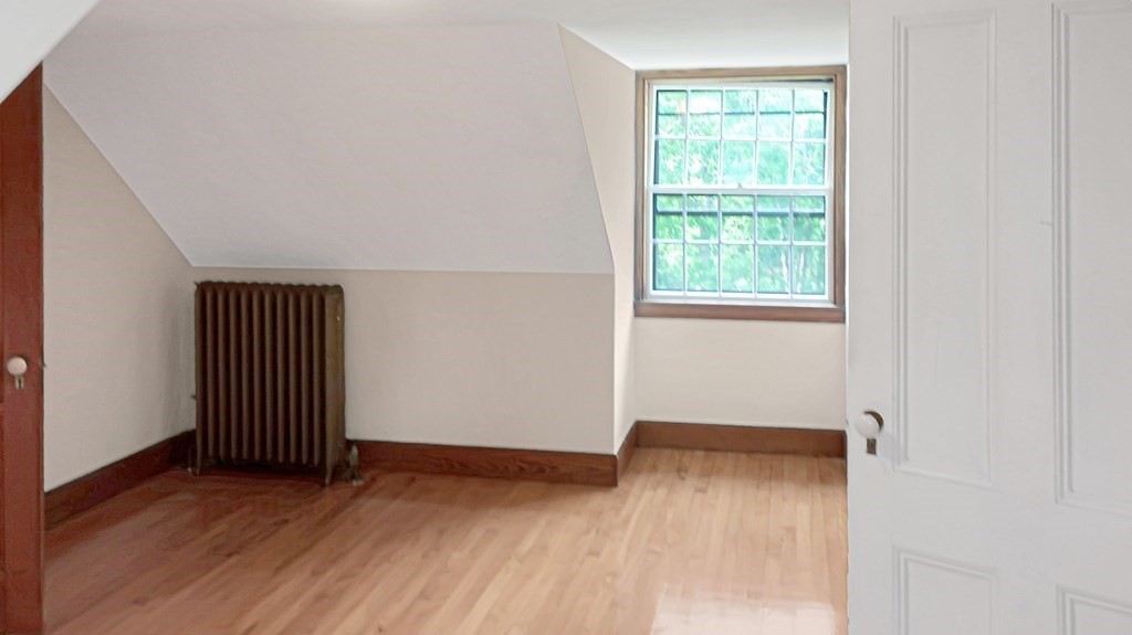 39 Locust Avenue Lexington, MA 02421 - Photo 22 of 32 an empty room with wooden floor and windows
