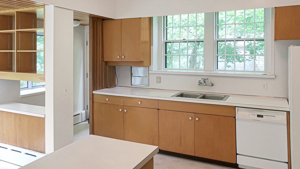 39 Locust Avenue Lexington, MA 02421 - Photo 10 of 32 a kitchen with white cabinets and a sink