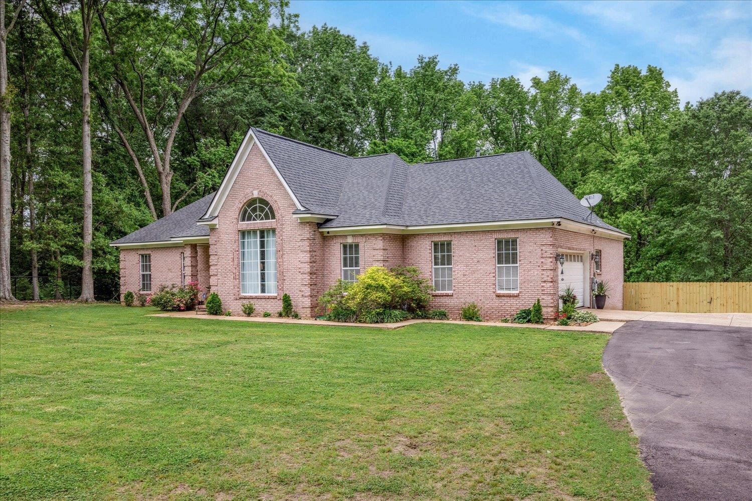 5950 Benjestown Road Memphis, TN 38127 - Photo 3 of 25 View of front of property with brick siding, a garage, asphalt driveway, and roof with shingles