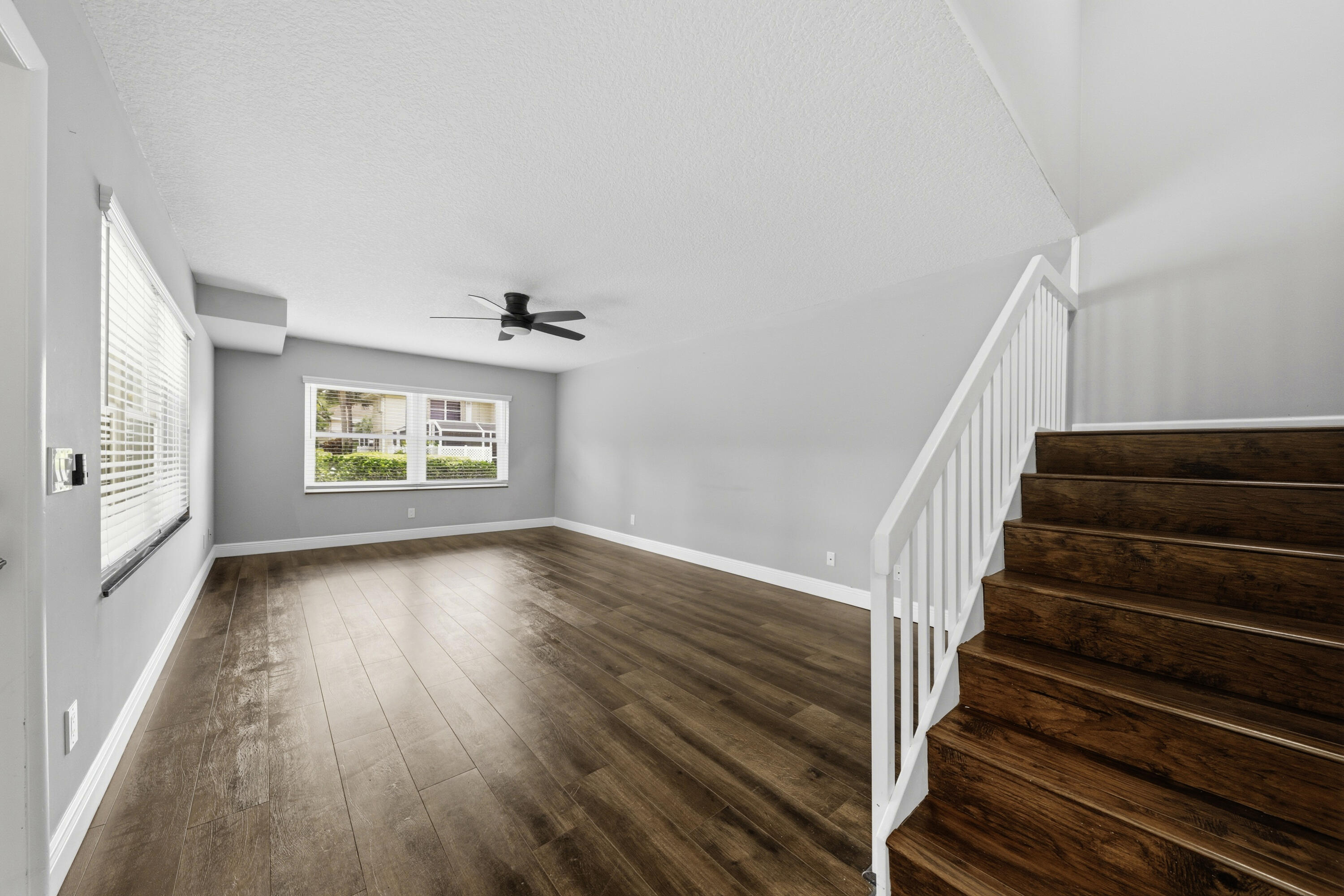 4802 Roxbury Court Boynton Beach, FL 33436 - Photo 12 of 41 a view of an empty room with wooden floor and a window