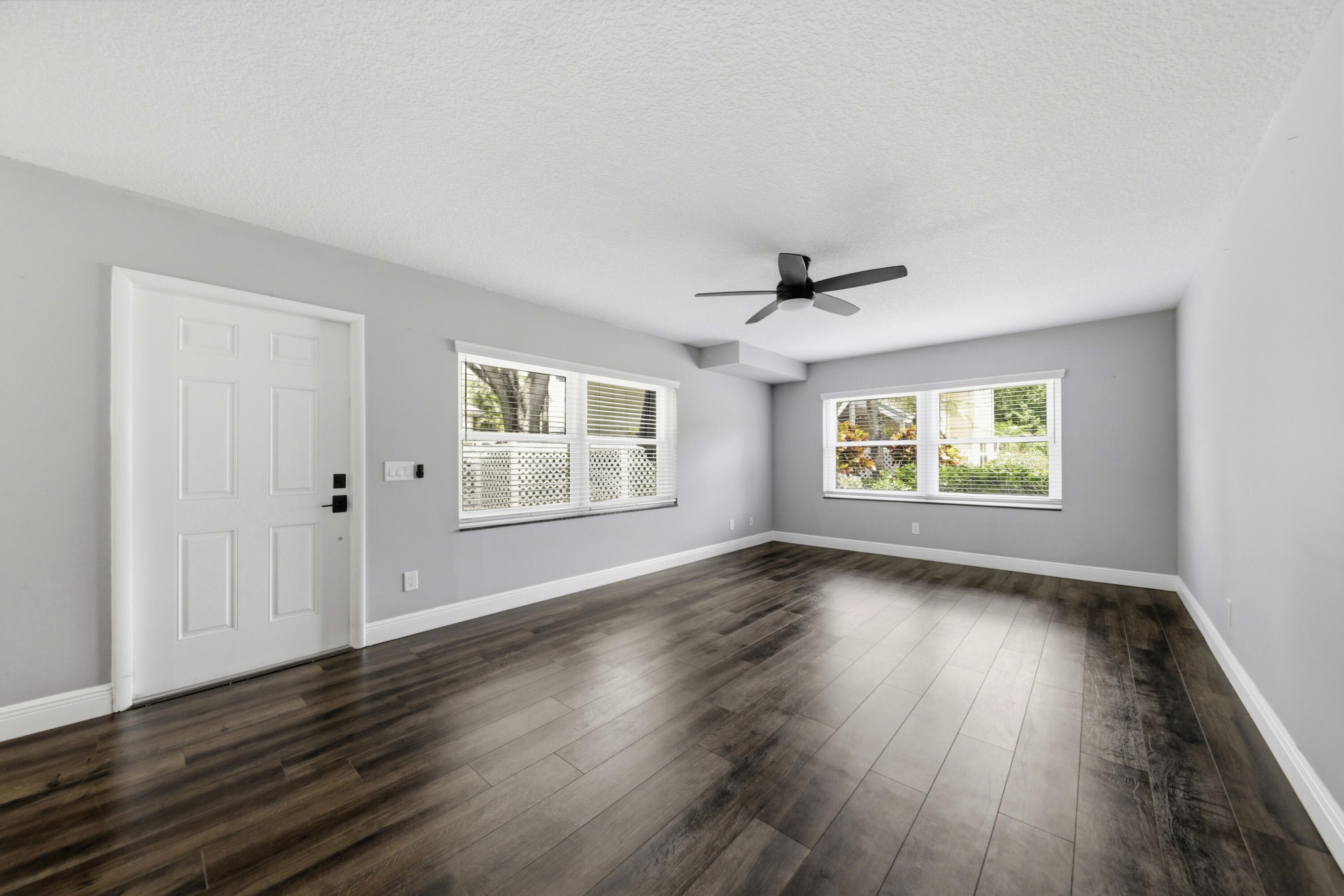 4802 Roxbury Court Boynton Beach, FL 33436 - Photo 14 of 41 an empty room with wooden floor and windows