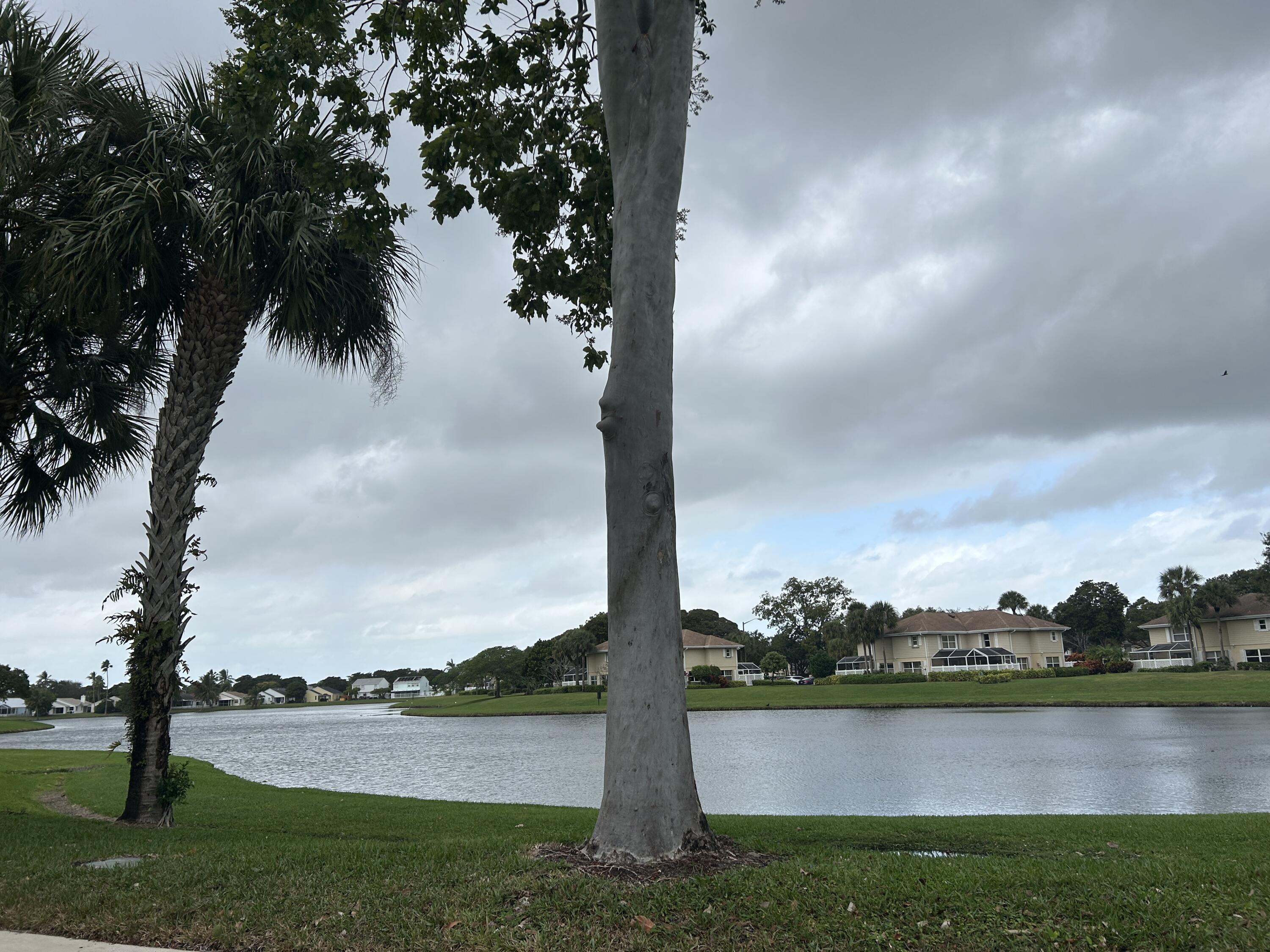 4802 Roxbury Court Boynton Beach, FL 33436 - Photo 32 of 41 a view of a lake with houses in the background