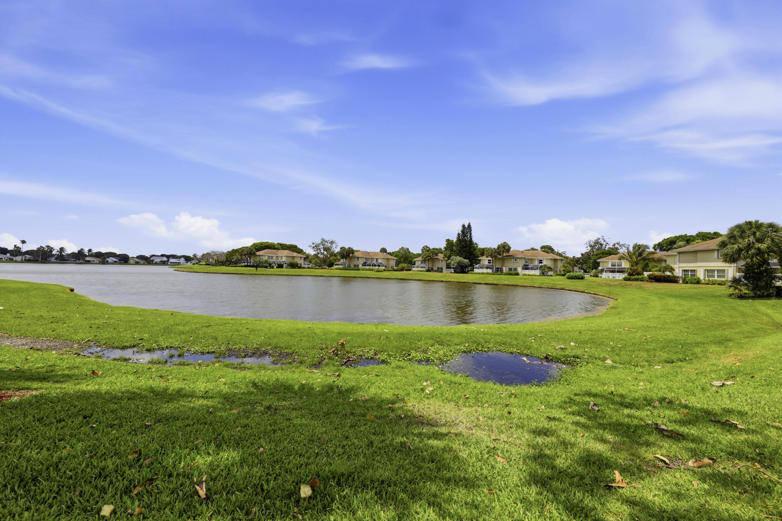 4802 Roxbury Court Boynton Beach, FL 33436 - Photo 39 of 41 a view of a lake with houses in the back