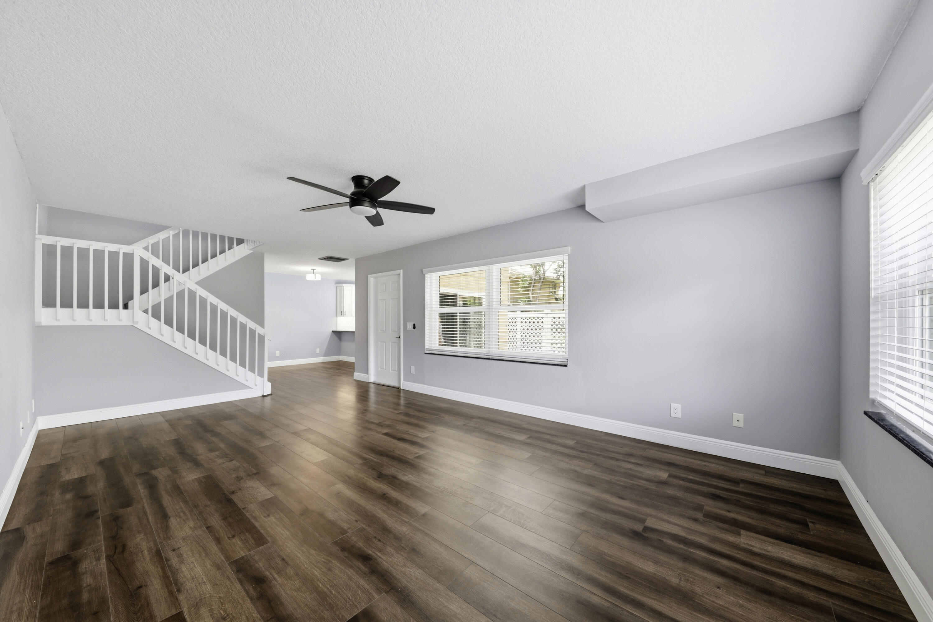 4802 Roxbury Court Boynton Beach, FL 33436 - Photo 4 of 41 a view of an empty room with wooden floor and a window