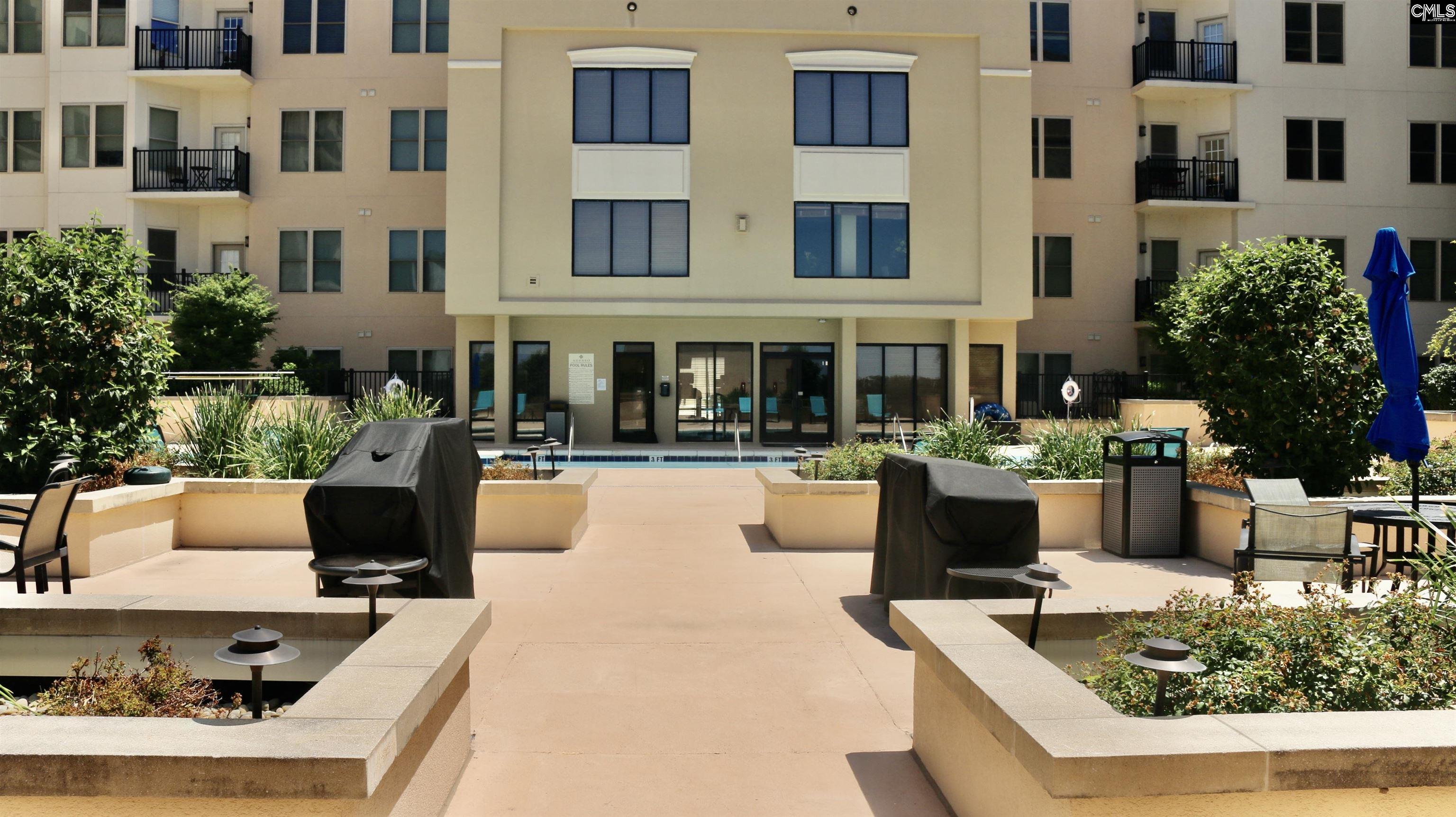 601 Main Street, Unit 323 Columbia, SC 29201 - Photo 60 of 68 a view of a building with couches pool and a fire pit