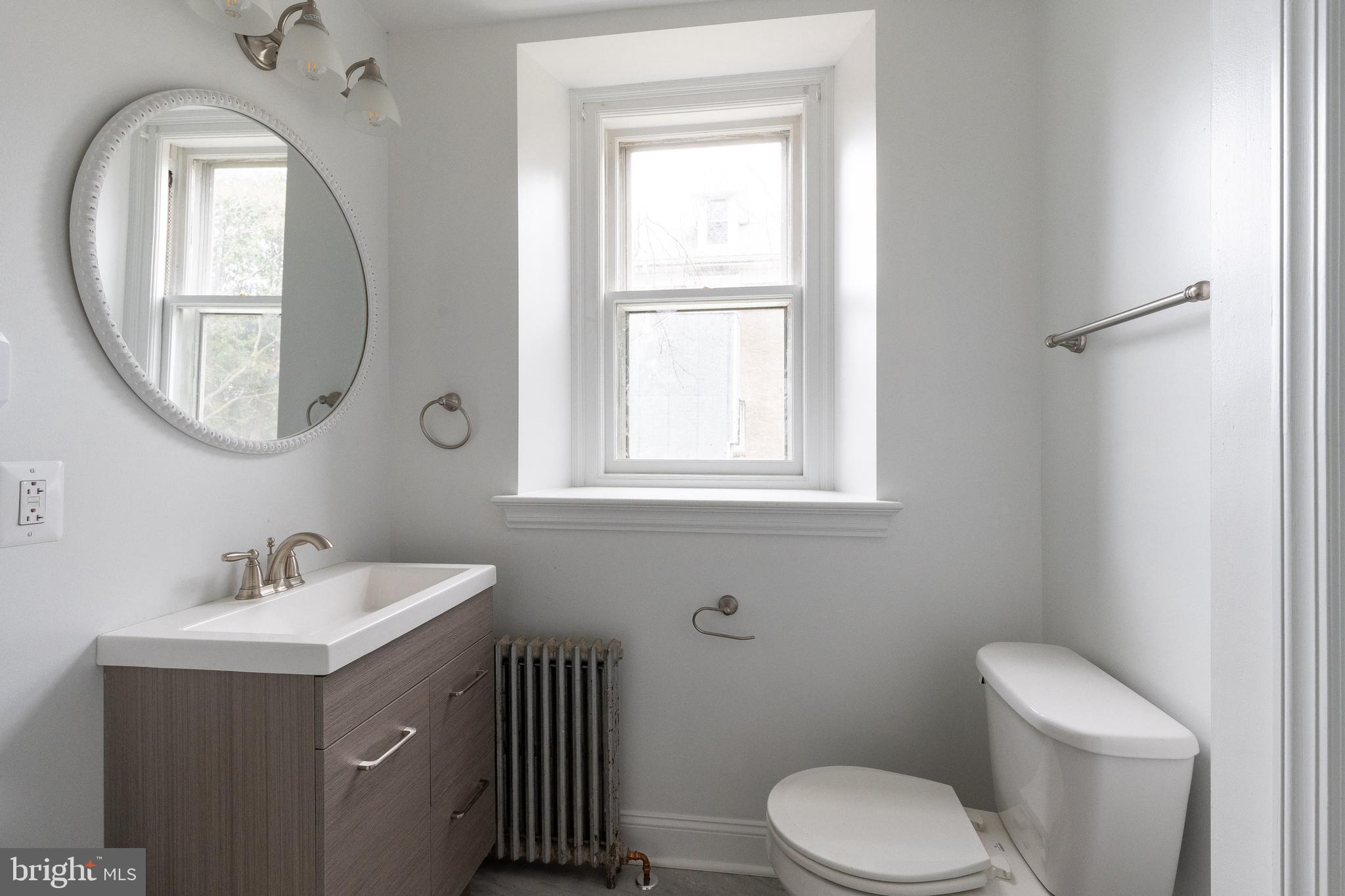 112 East Township Line Road Havertown, PA 19083 - Photo 11 of 40 a bathroom with a toilet sink and mirror