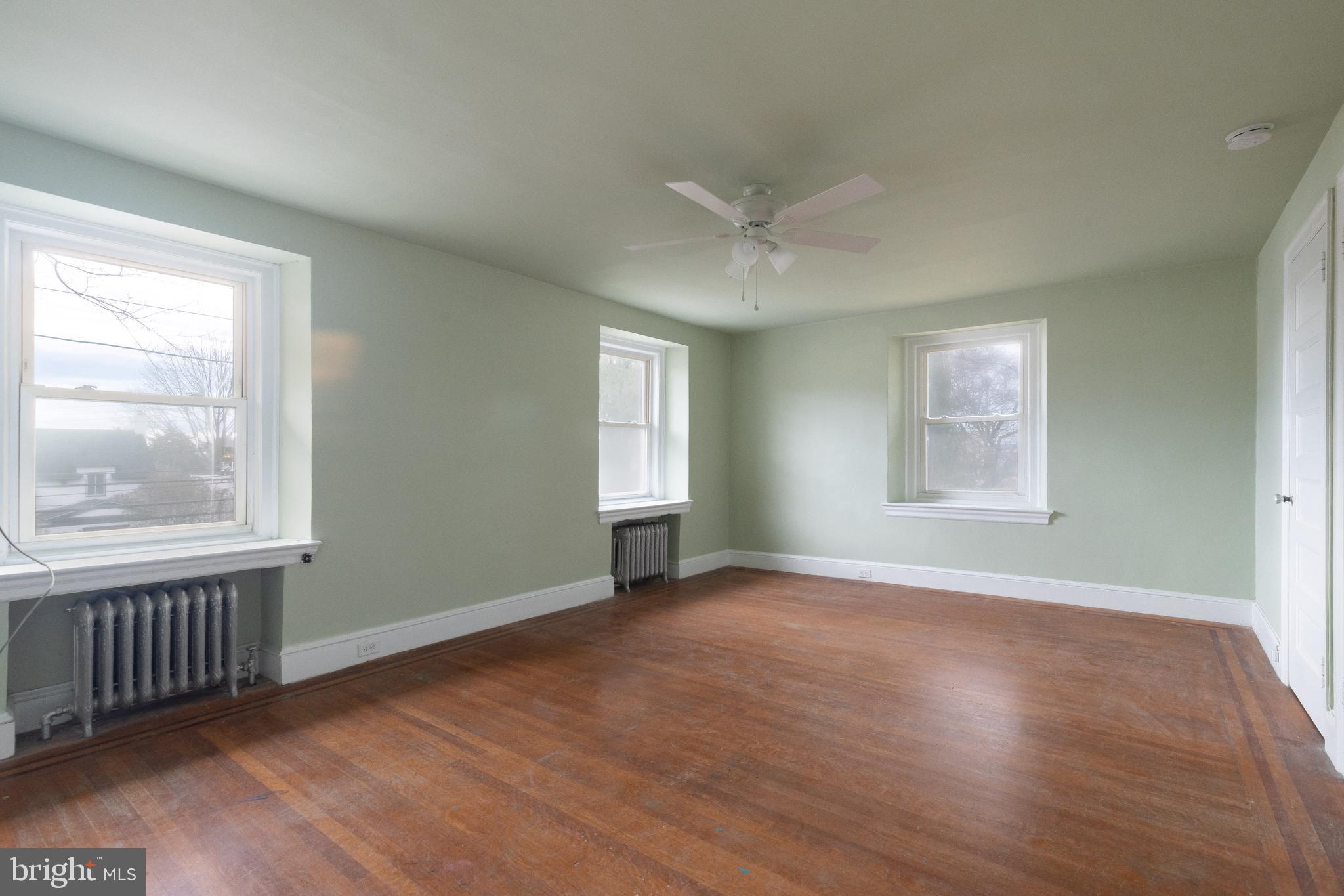 112 East Township Line Road Havertown, PA 19083 - Photo 12 of 40 a view of an empty room with wooden floor and a window