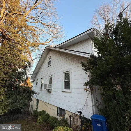 a view of a house with a tree in the background