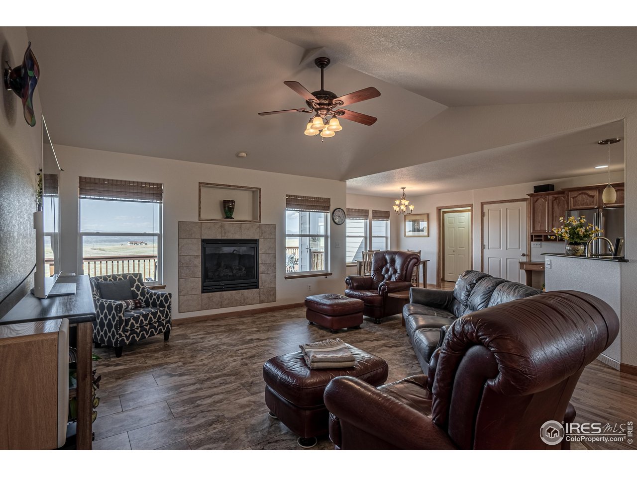 631 Linecamp Drive Livermore, CO 80536 - Photo 12 of 41 a living room with furniture a fireplace and a flat screen tv