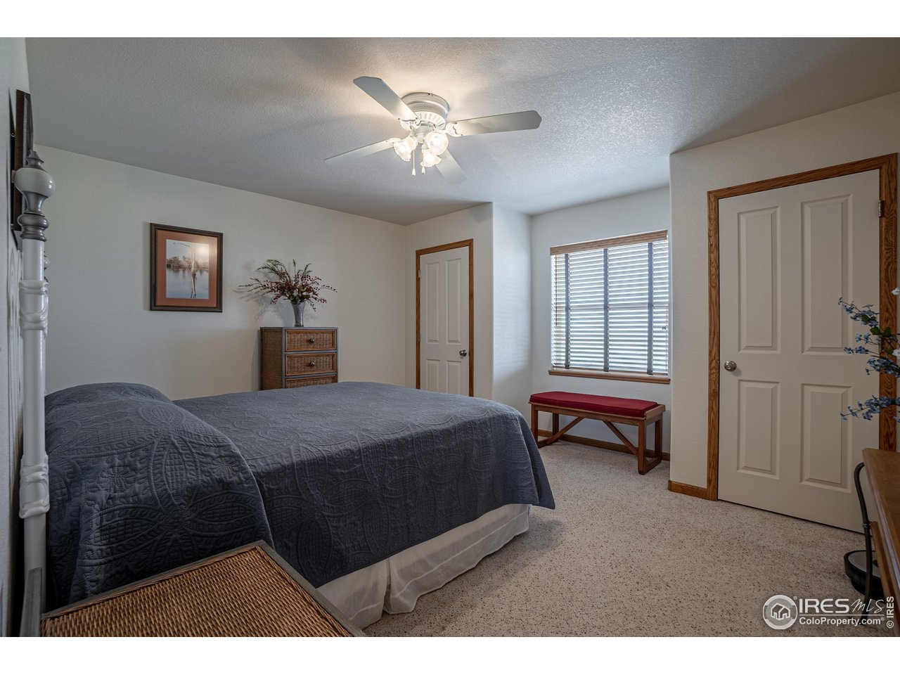 631 Linecamp Drive Livermore, CO 80536 - Photo 15 of 41 a bedroom with a bed and a chandelier